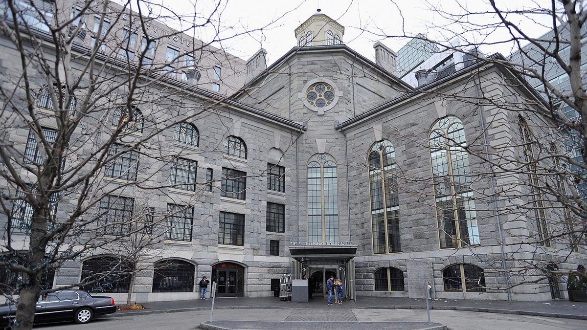 The Liberty Hotel in Boston, Massachusetts, seen from outside with people and limo out front.