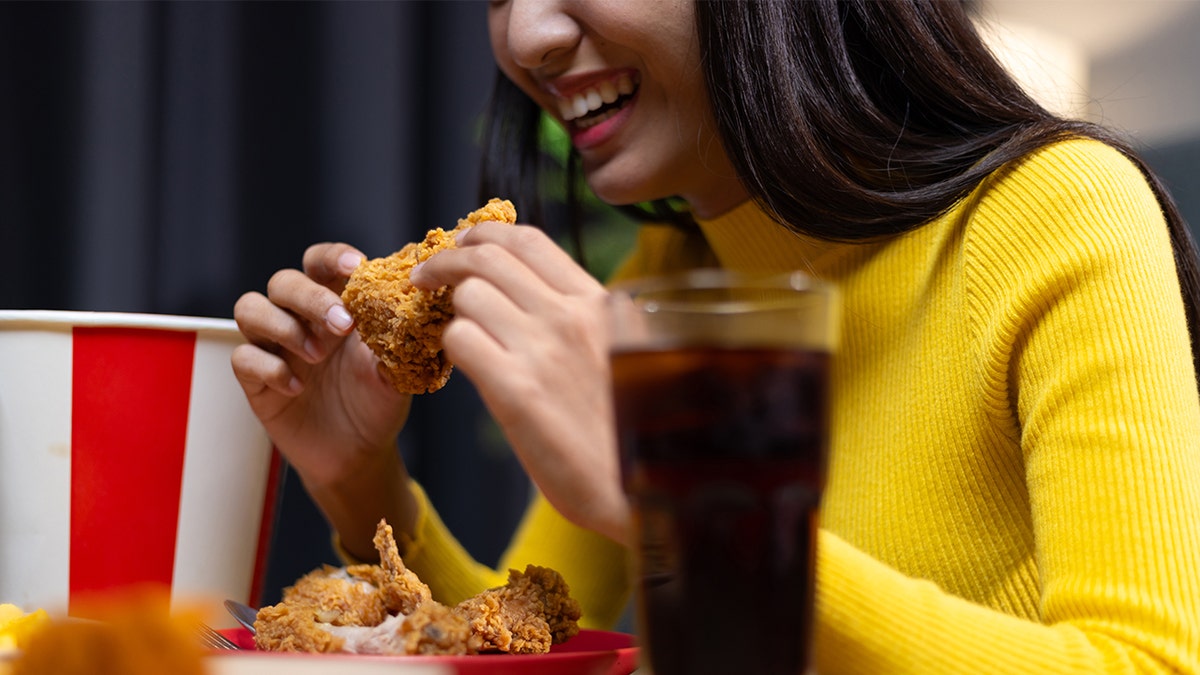 Woman eating from KFC bucket
