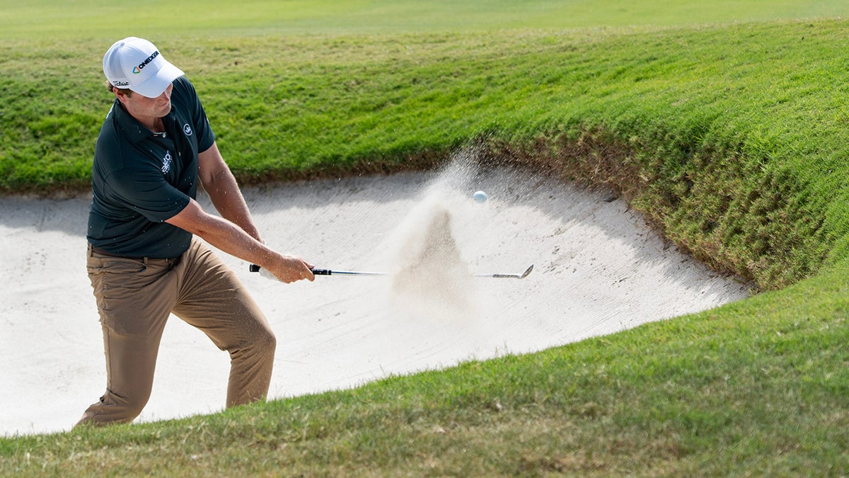 Vince Whaley hits a ball out of the bunker