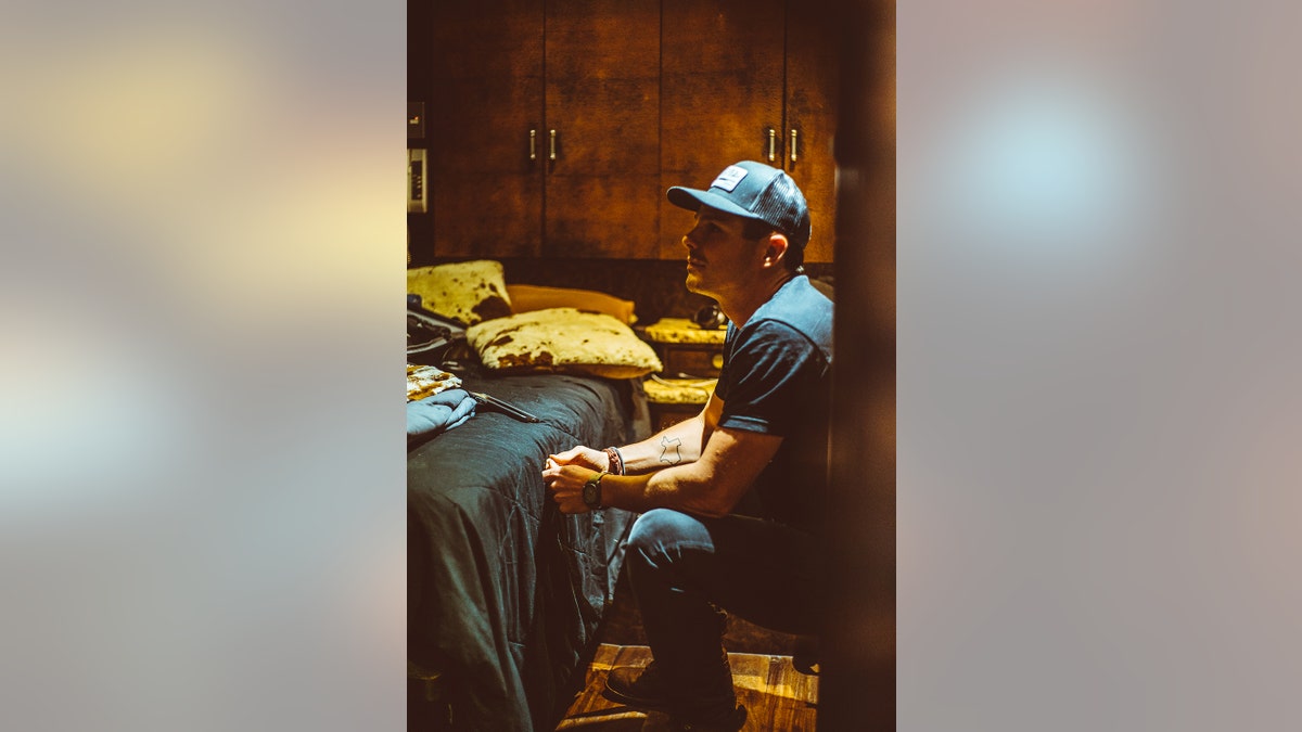 Granger Smith looking pensive in his tour bus.