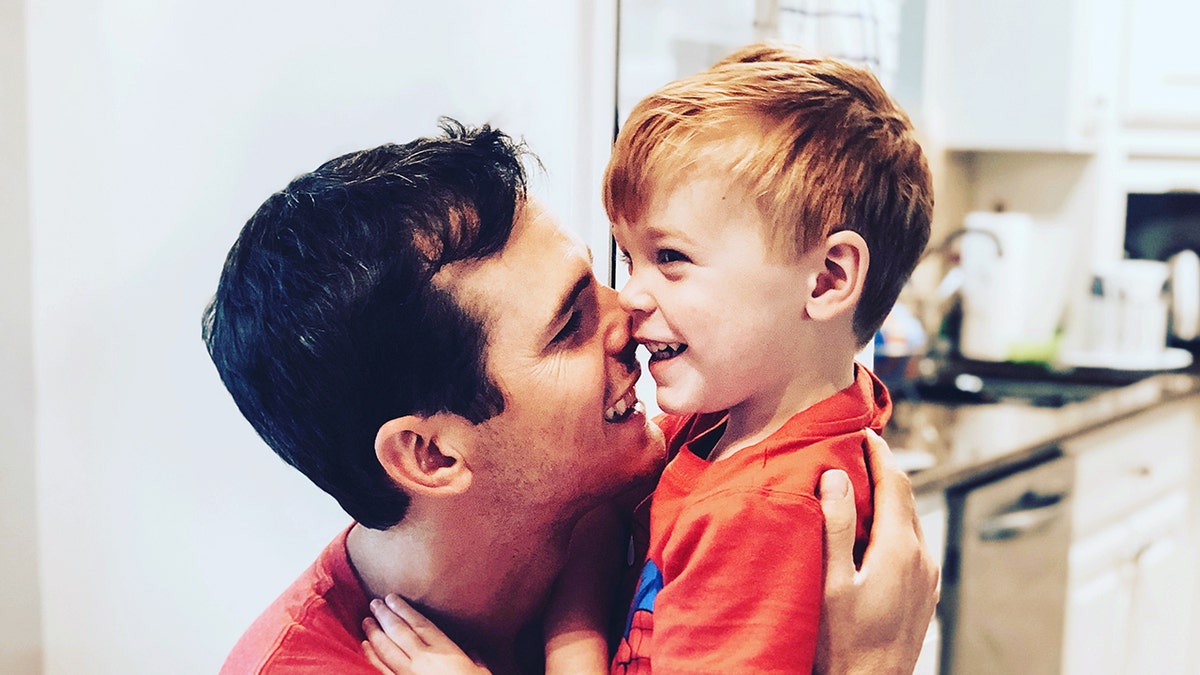 Granger Smith is seen here cuddling and smiling with his son River.