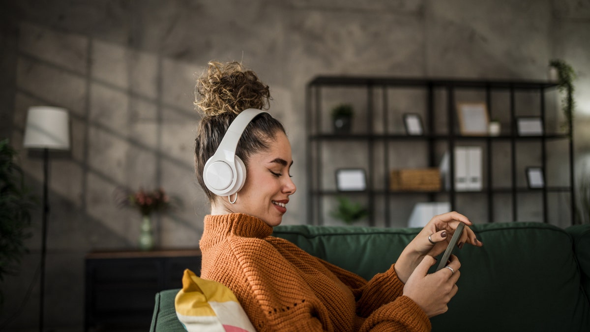 woman listening to music on wireless headphones