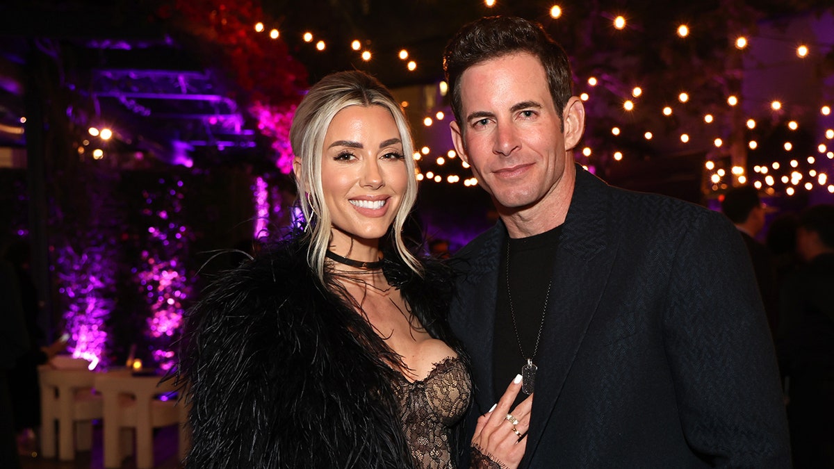 Heather Rae El Moussa and Tarek El Moussa pose together.