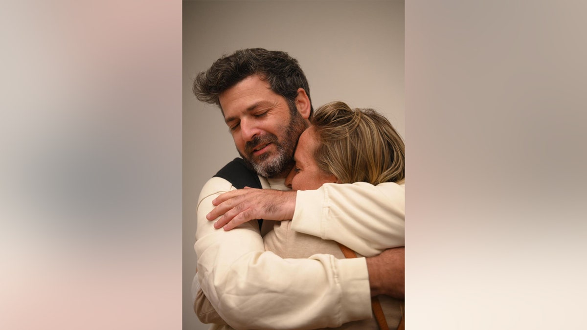 A man and woman hug