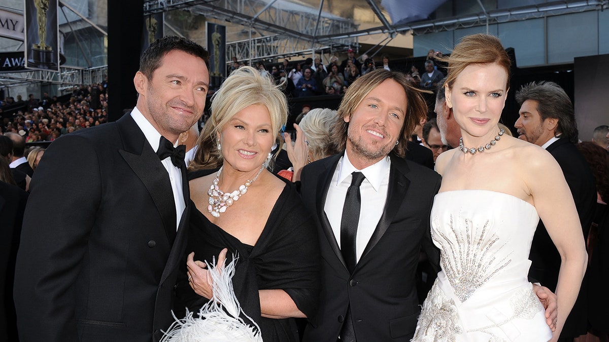 Hugh Jackman, Deborra-Lee Furness, Keith Urban, and Nicole Kidman smile on the recarpet at the 83rd Academy Awards in 2011.
