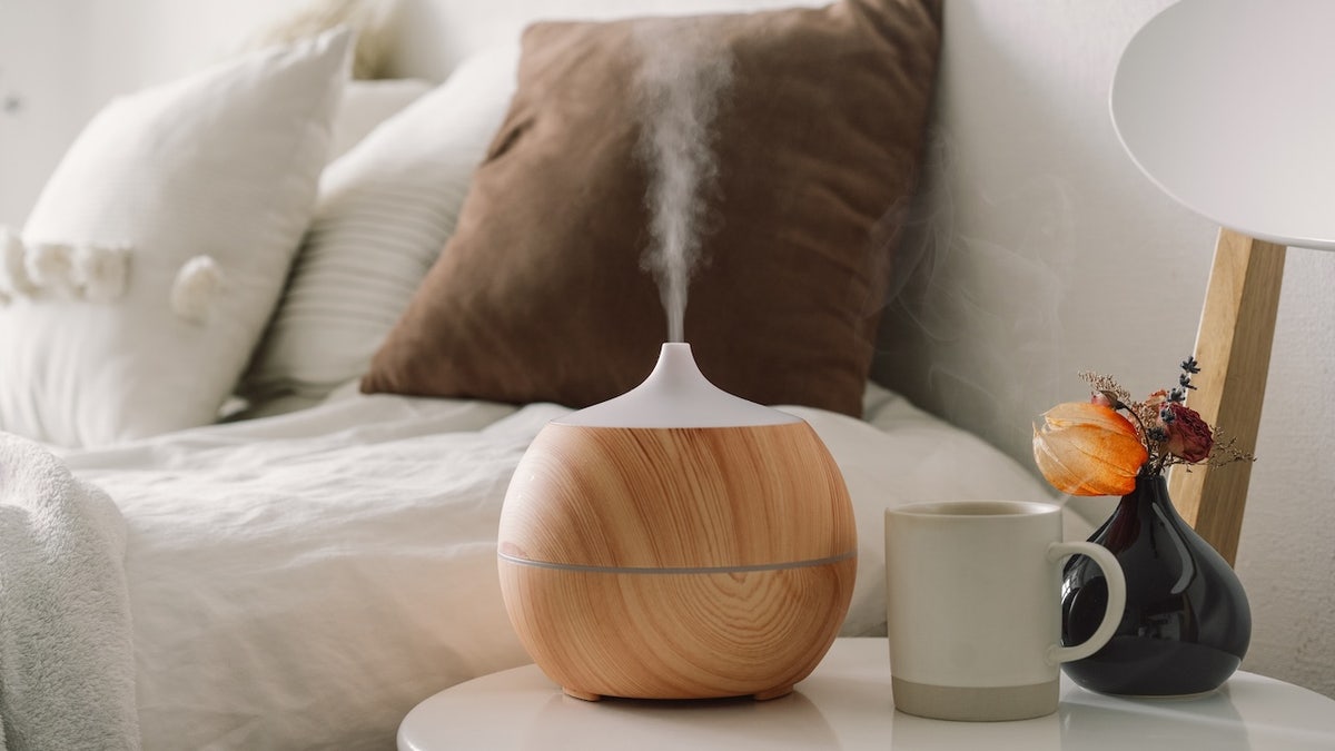 Aroma oil diffuser on chair against in the bedroom.