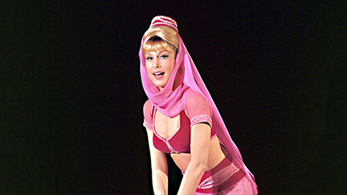 Barbara Eden wearing a pink genie costume as Jeannie.