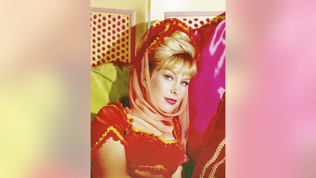 A close-up of Barbara Eden in her costume as Jeannie looking up.