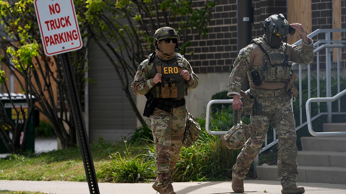 Enforcement and Removal Operations agents walking while wearing gear Enforcement and Removal Operations agents walking while wearing gear