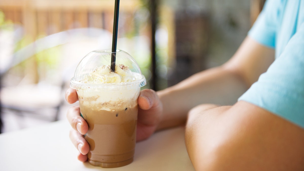 Man holding iced coffee