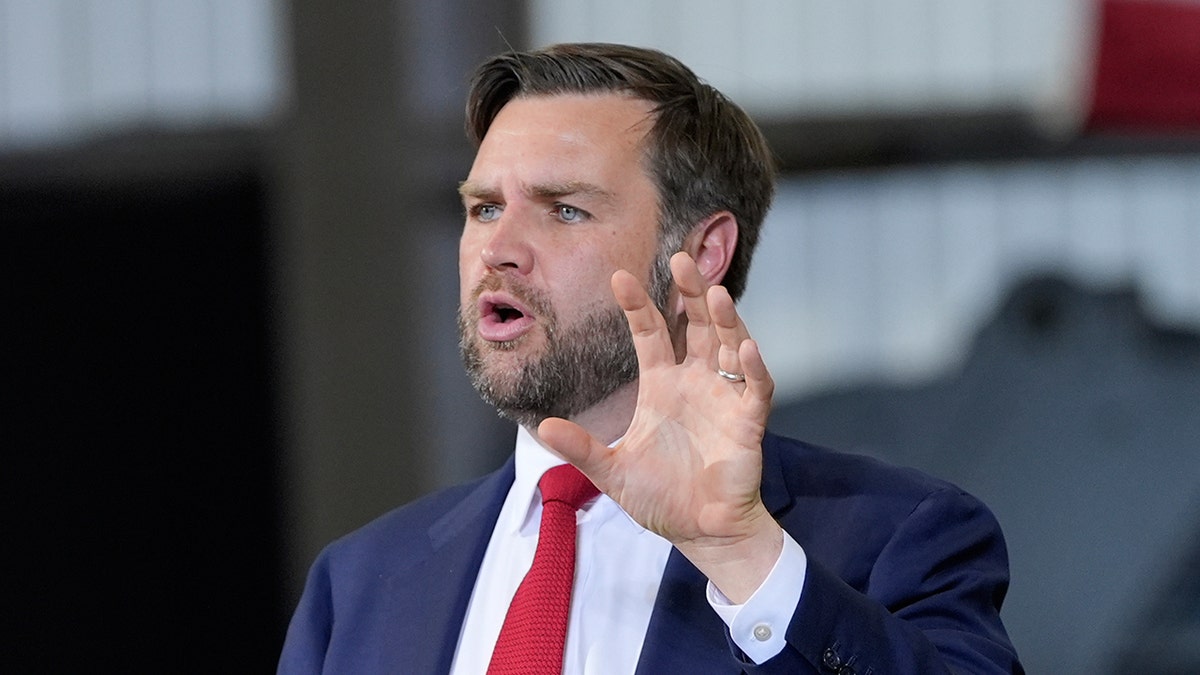 Vice President JD Vance speak in dark suit and red tie speaking