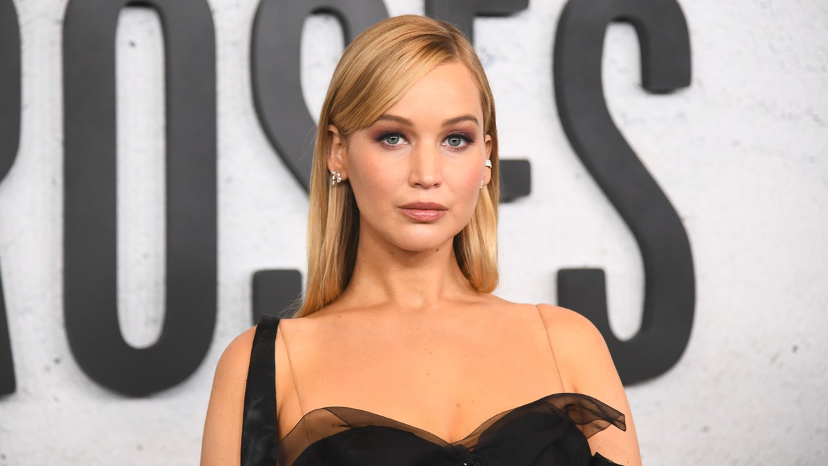 Jennifer Lawrence wears a black dress to a movie premiere