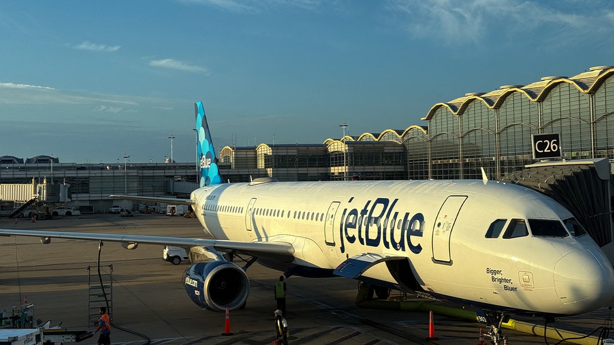 jetblue plane parket at gate at airport