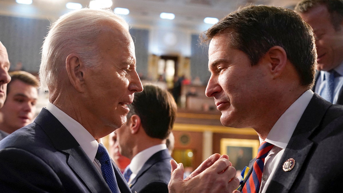 Then-President Joe Biden speaking with Rep. Seth Moulton