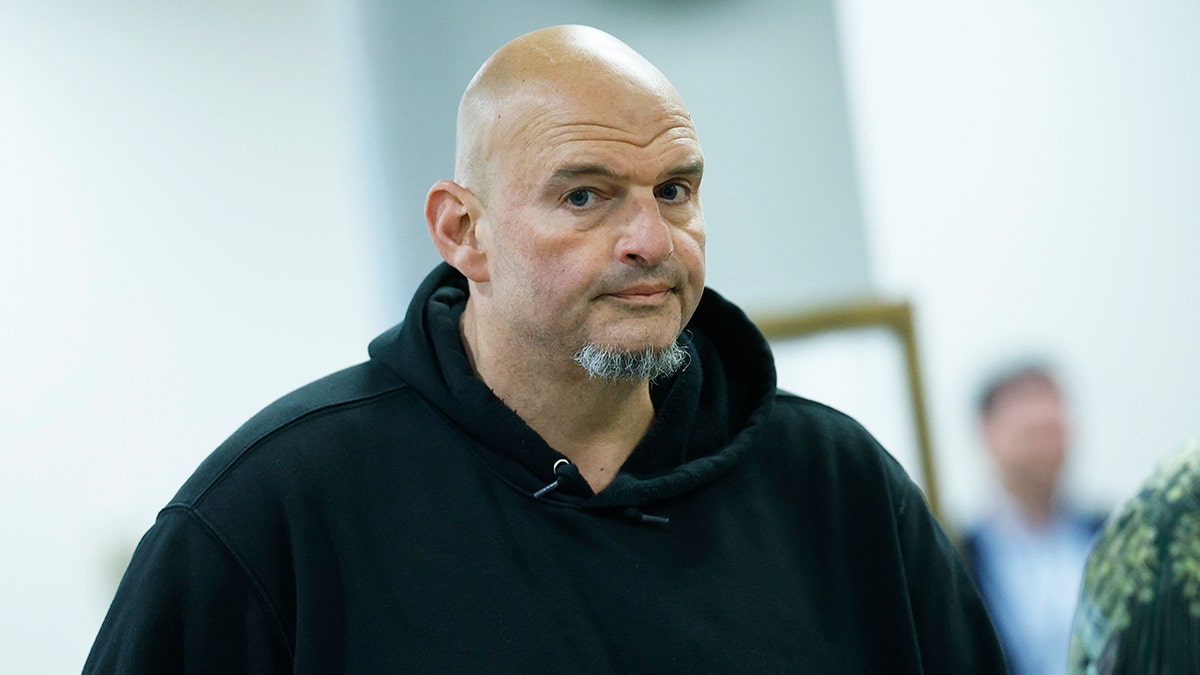 Sen. John Fetterman makes facial expression as he walks to vote
