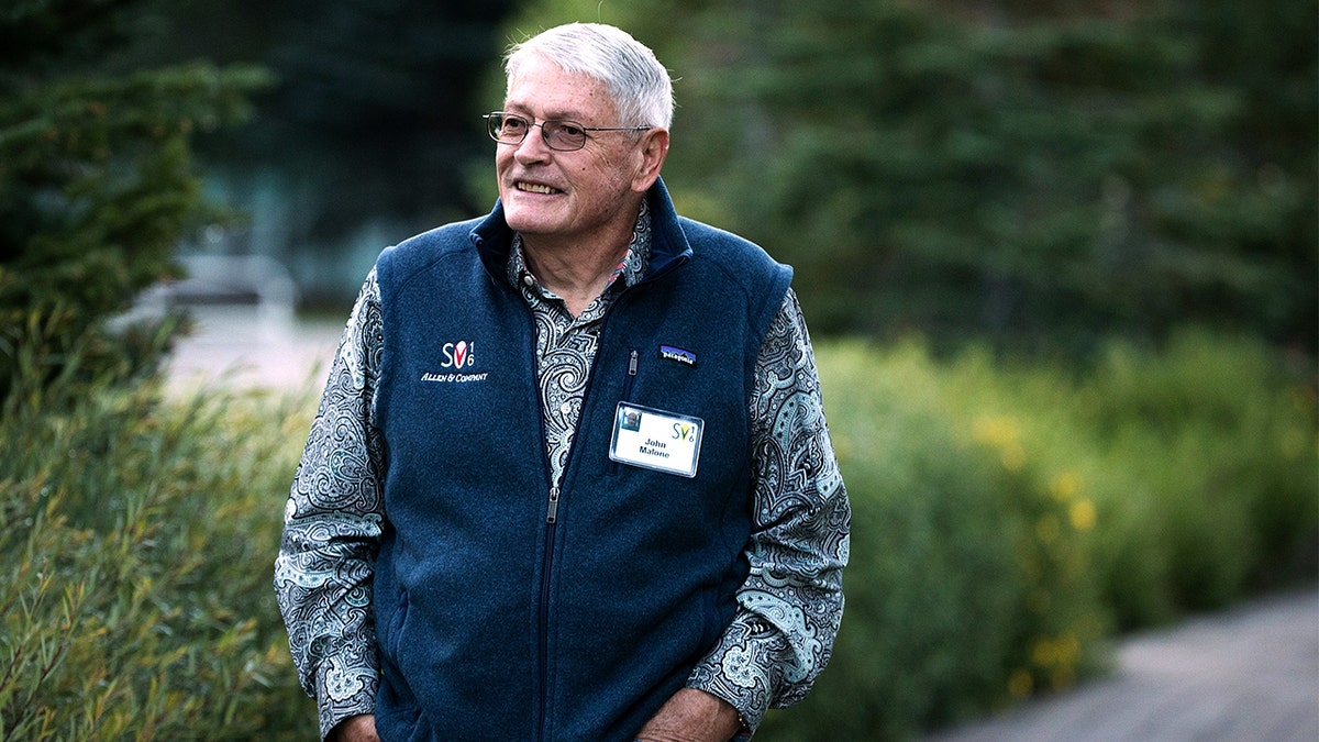 John Malone walking outside