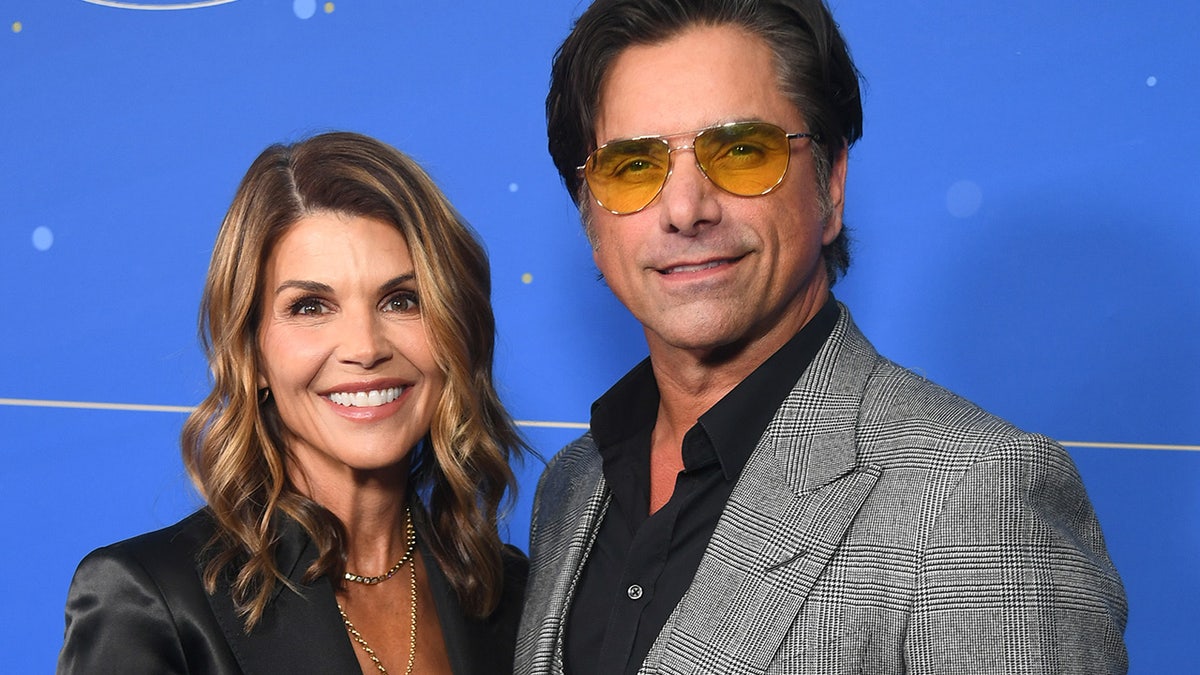 John Stamos and Lori Loughlin smiling