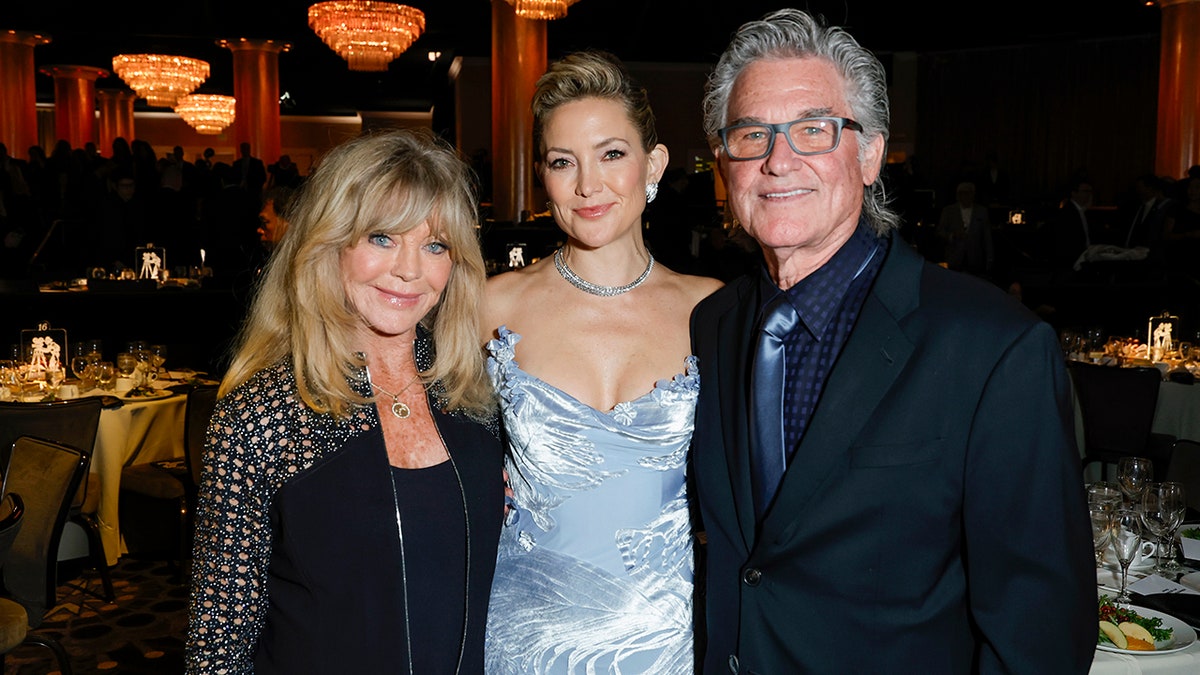 Goldie Hawn, Kate Hudson, and Kurt Russell pose together for a photo.