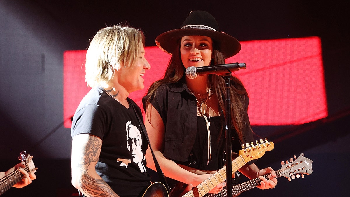 Keith Urban and Maggie Baugh perform together on stage in April 2024 at the CMT Music Awards