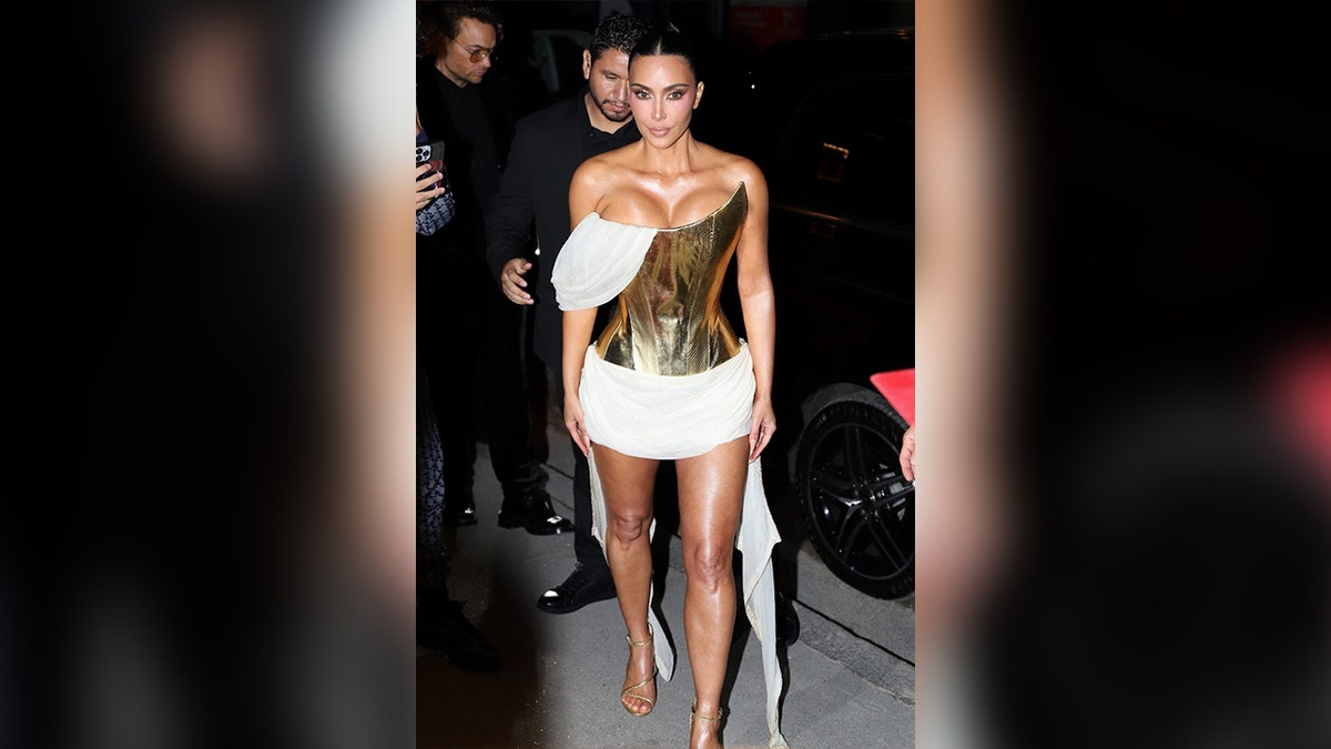 Kim Kardashian wears gold and white dress at Crazy Horse Paris