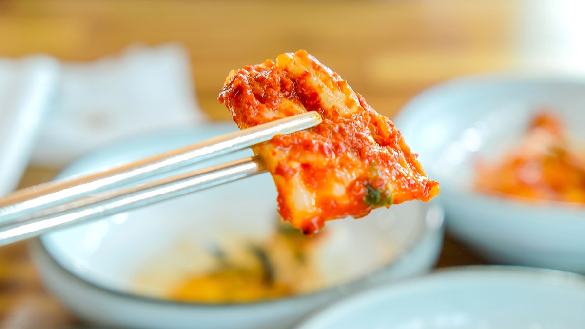 Close-up of kimchi piece with gochujaru sauce