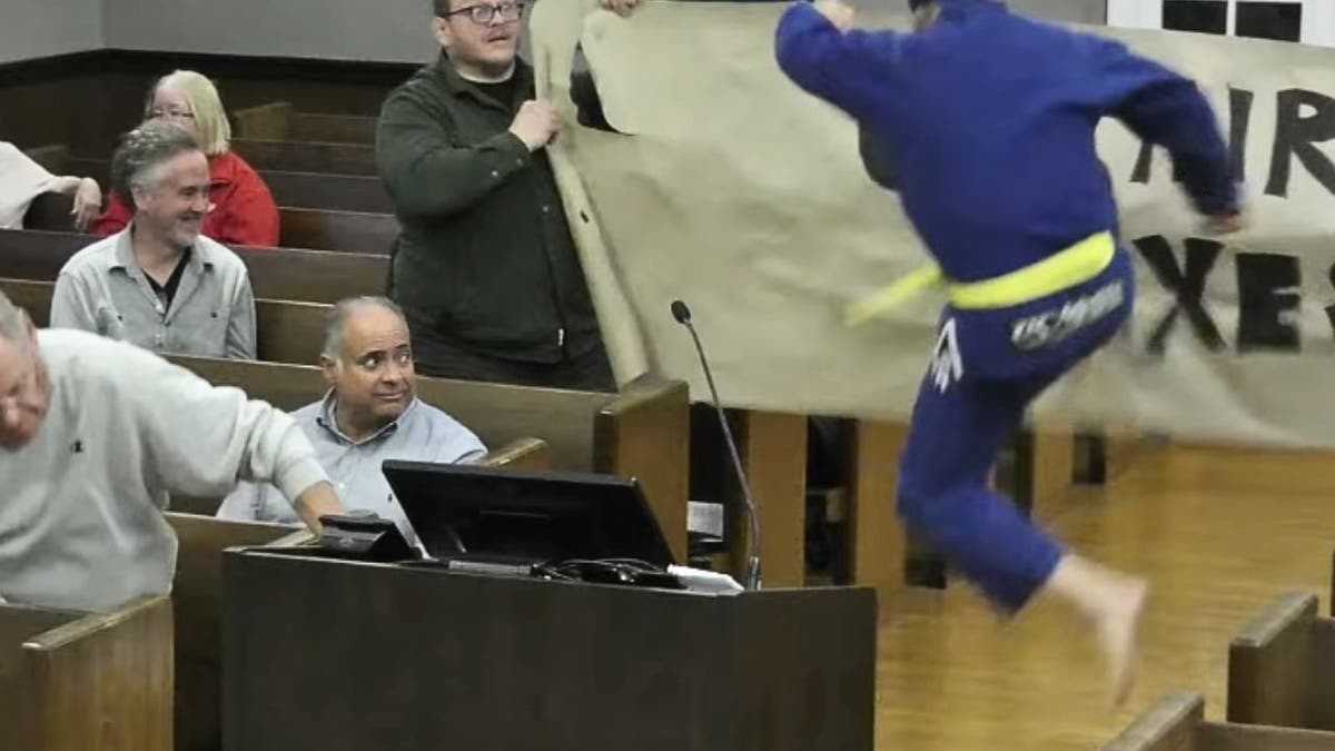 kung-fu-kick Cranford candidate Will Thiele Kung Fu kicks through protest signs