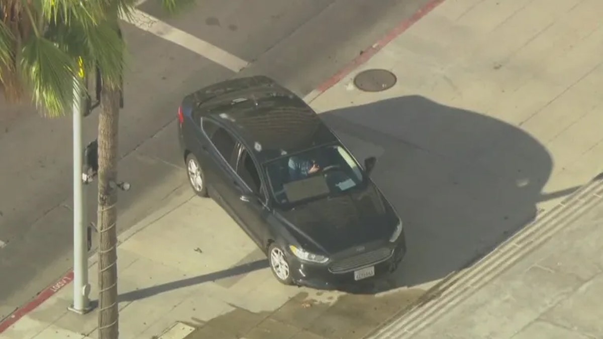 Car on steps of City Hall in LA