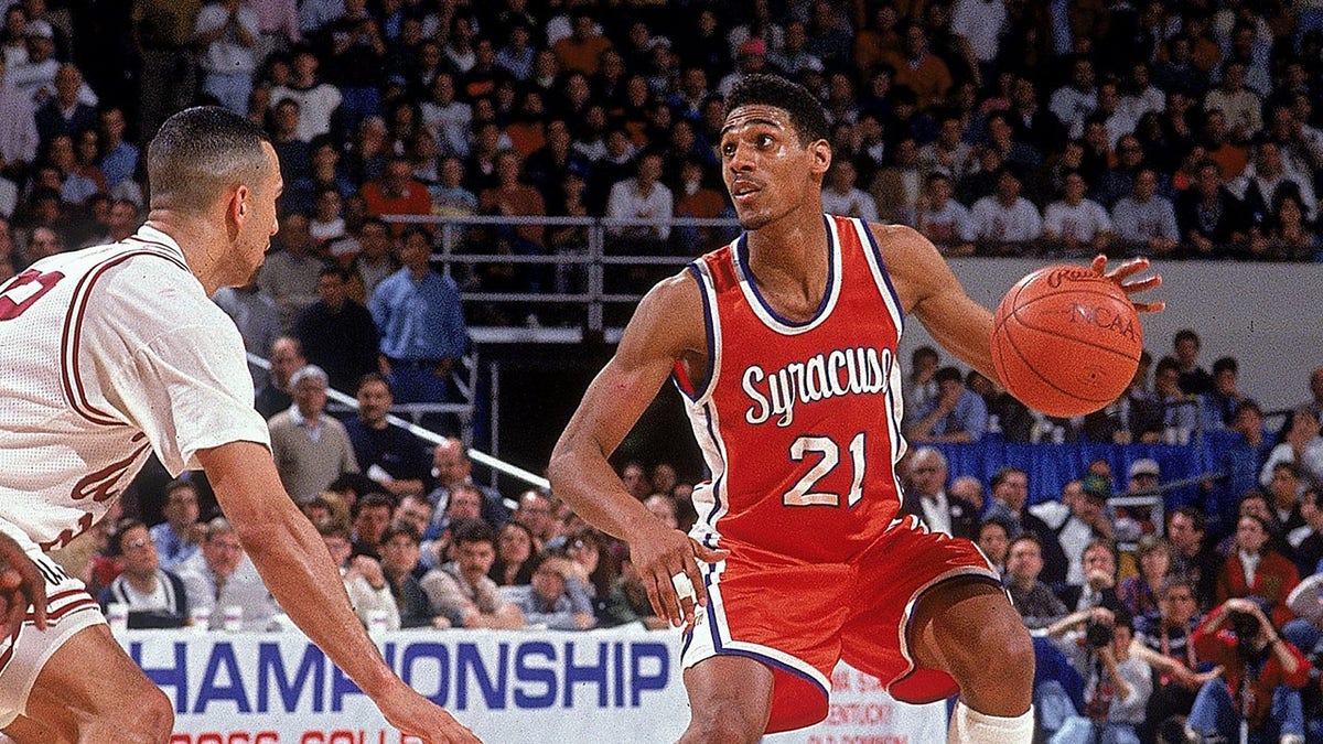 Lawrence Moten looks on court with ball