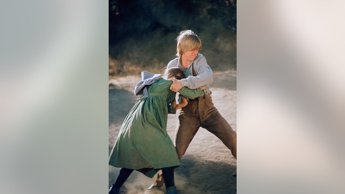 Michael LeClair dragging Melissa Gilbert in "Bully Boys."