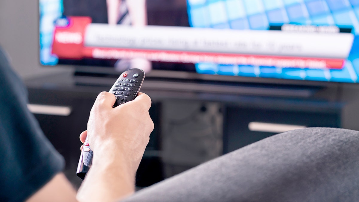 A man watches a media news program