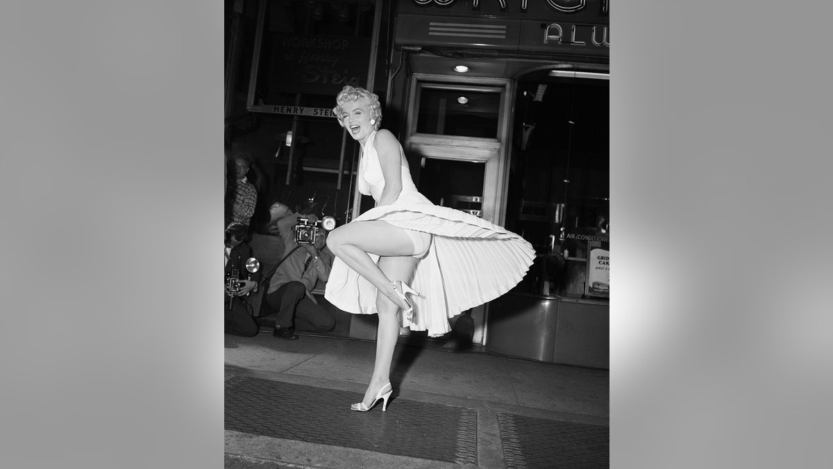 Marilyn Monroe laughing as her skirt flies up.
