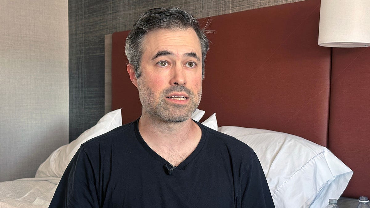 Antifa professor Mark bray in black shirt in hotel room