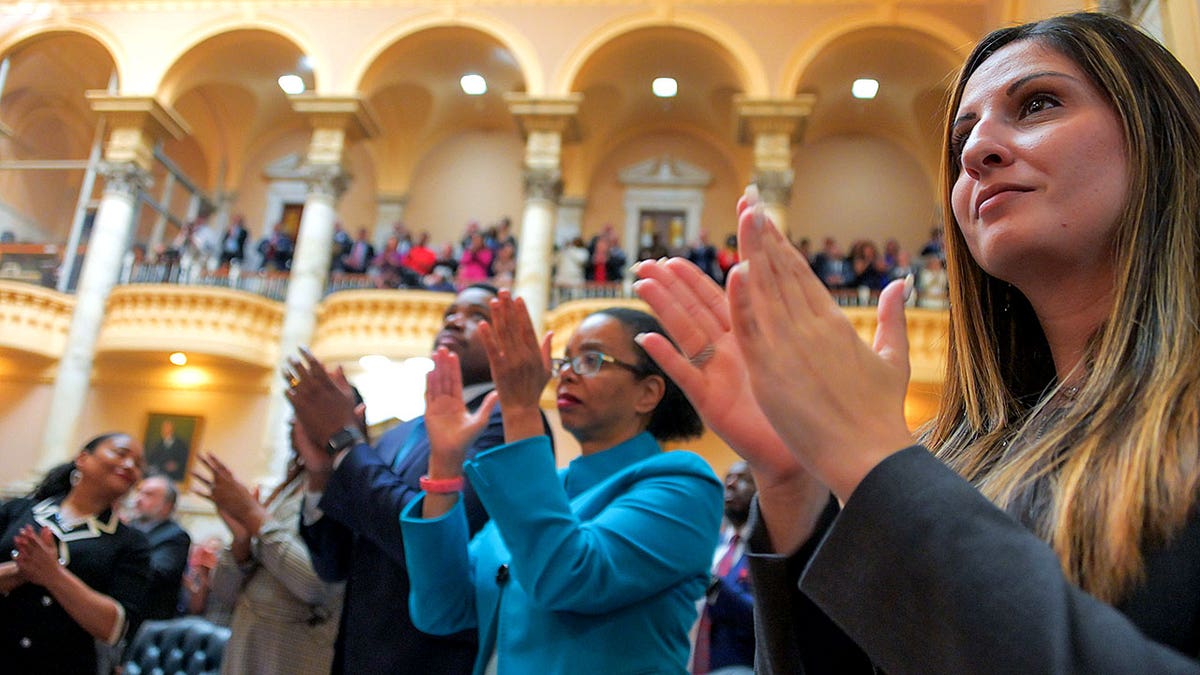 Maryland State Senator Dalya Attar clapping.