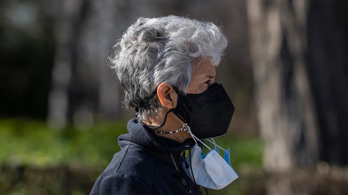 Woman wears COVID-19 mask to protect herself