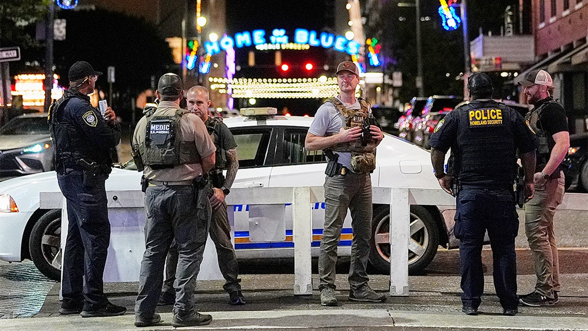Federal law enforcement officers standing at the intersection of Beale Street and North Second Street in Memphis