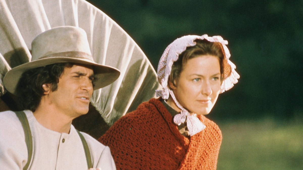 Karen Grassle as Ma looking stern as Michael Landon, as Charles Ingalls, looks on.