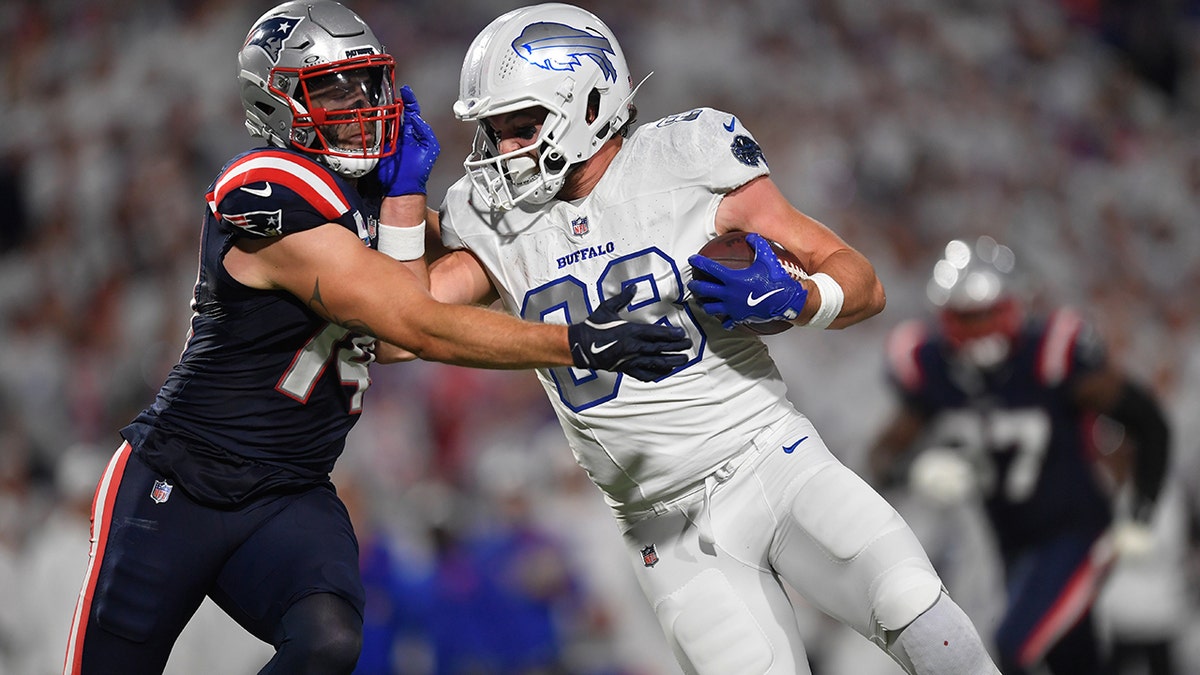 Dawson Knox delivers a stiff arm