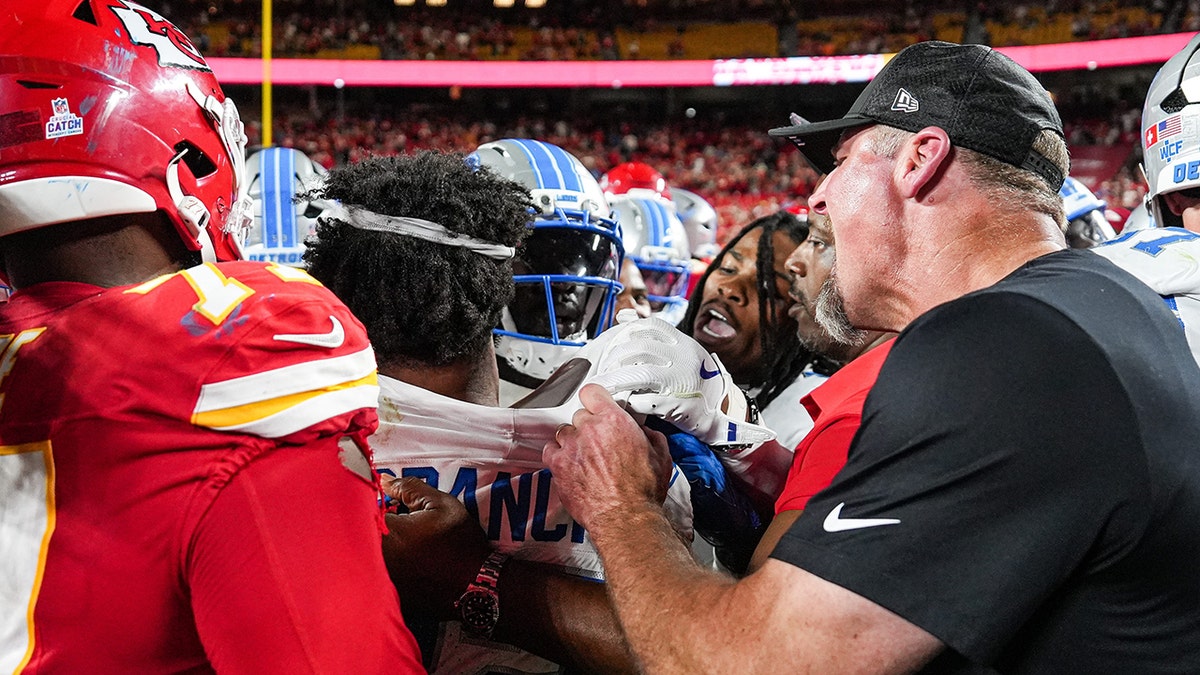 Dan Campbell tries to get Brian Branch out of the fray