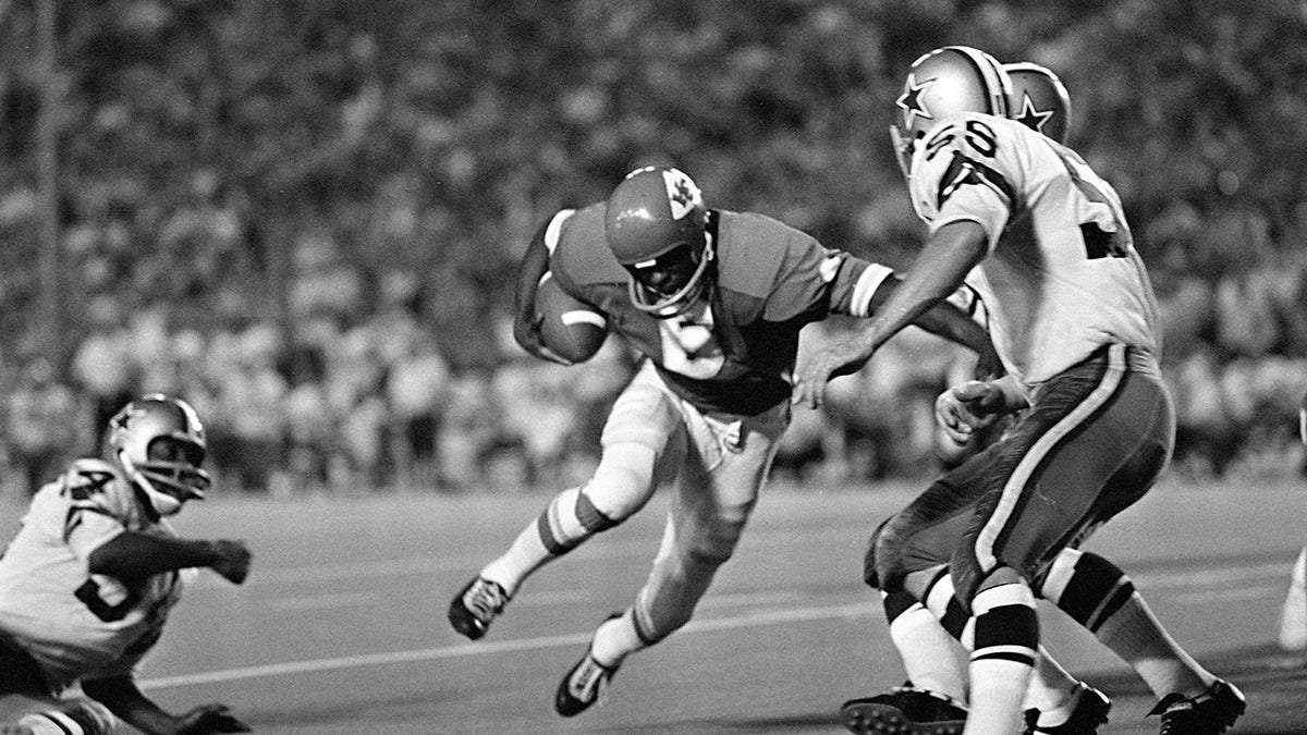 Warren McVea is tackled by a defender