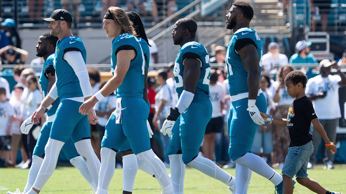 Jaguars players walk to midfield