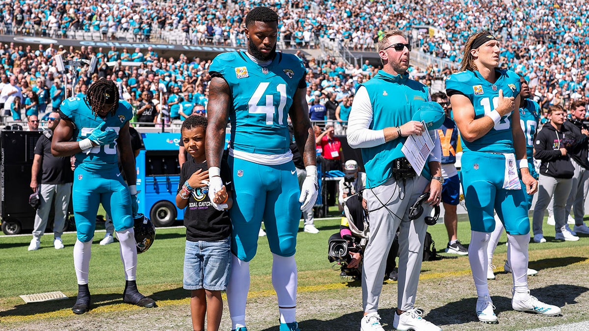 Josh Hines-Allen stands with his son, Wesley