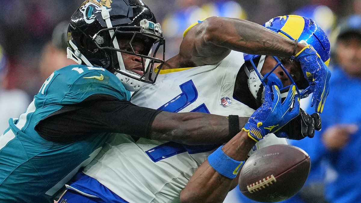 Travis Hunter tries to break up a catch