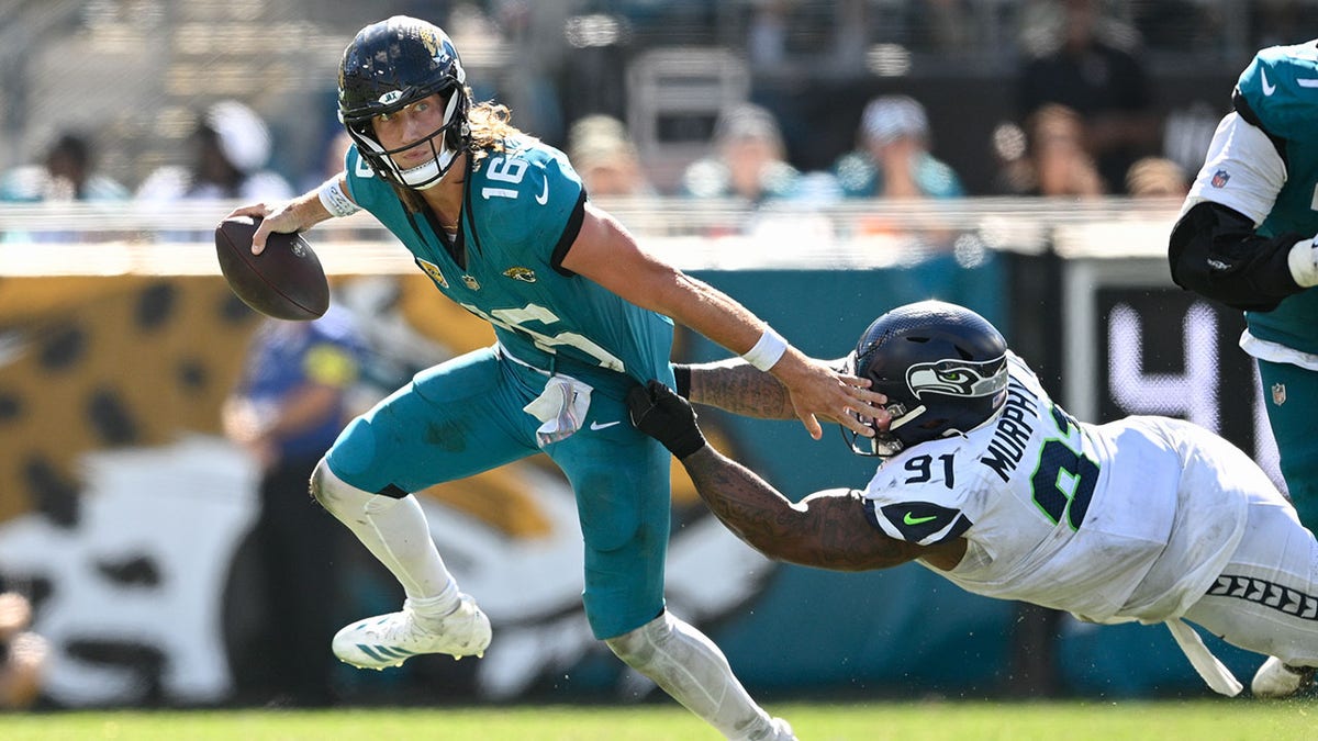 Trevor Lawrence escapes a tackle