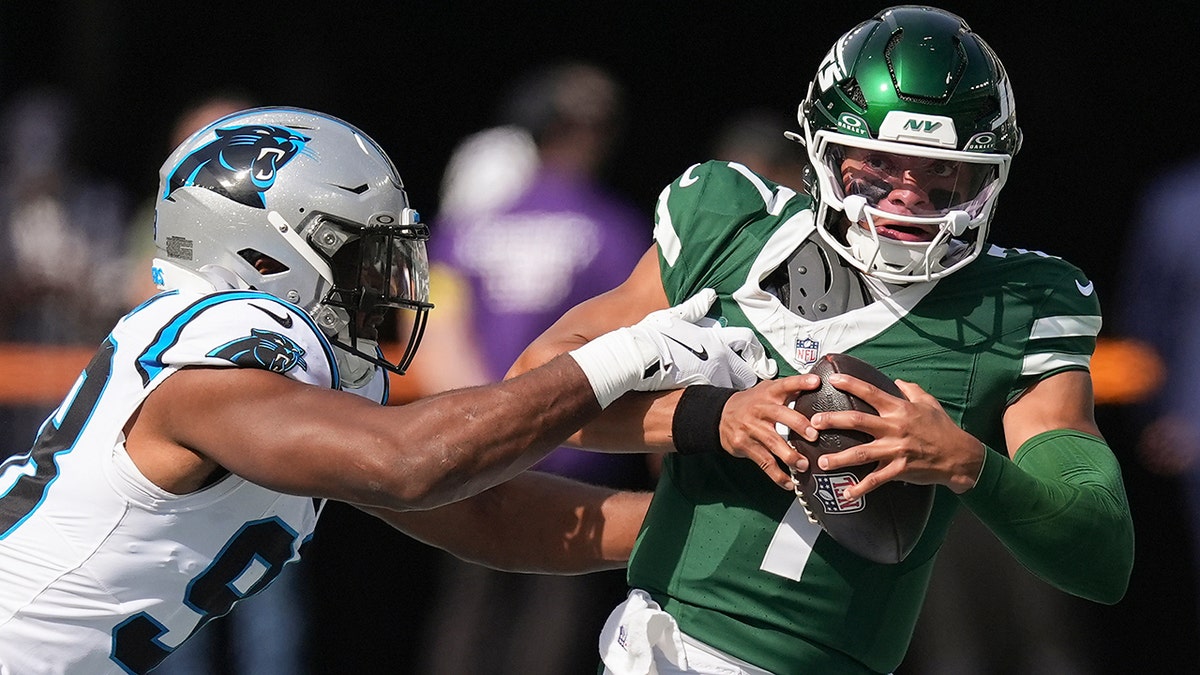 Justin Fields tries to avoid a tackle