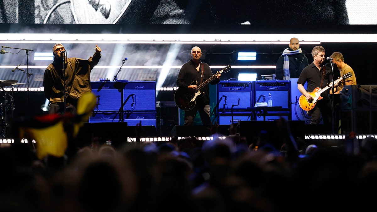 Liam Gallagher, Noel Gallagher, and Paul 