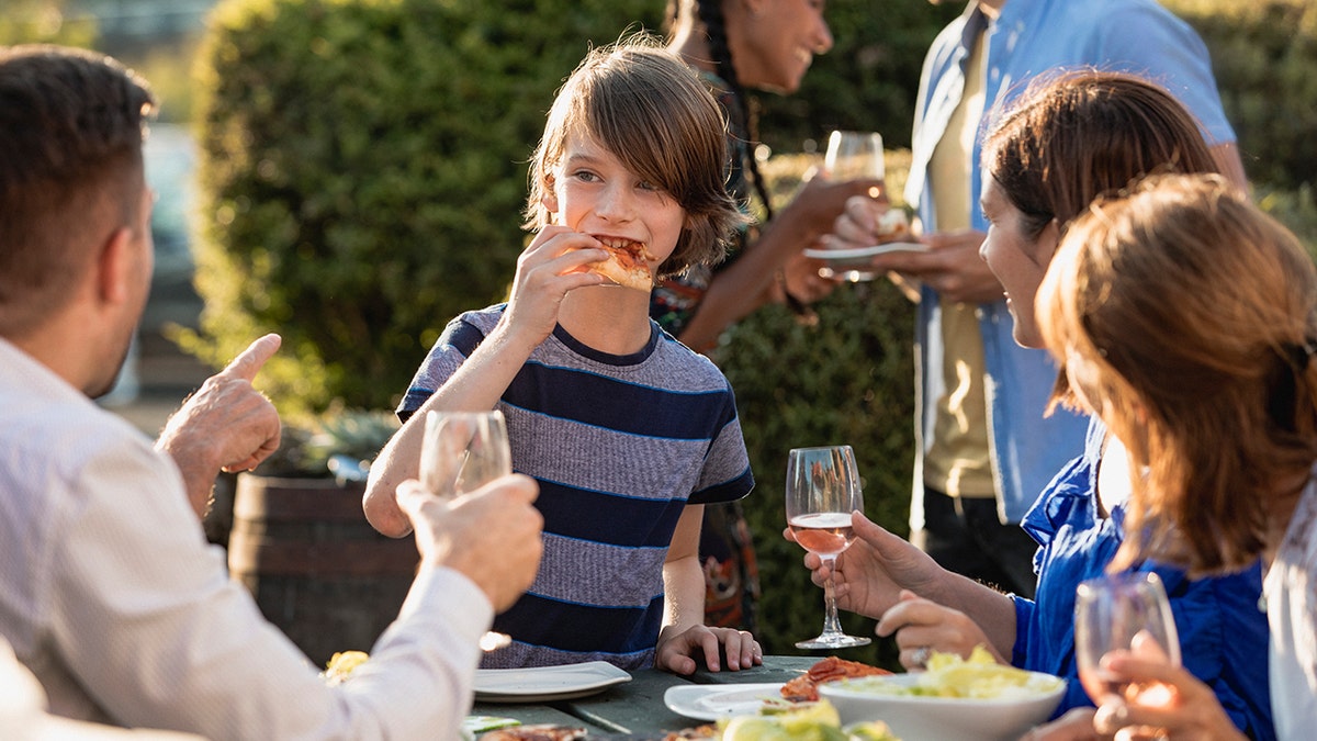 Kid eating pizza at beer garden