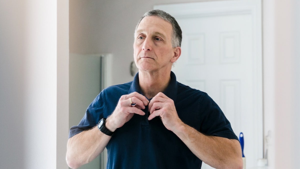 Older man getting ready for work
