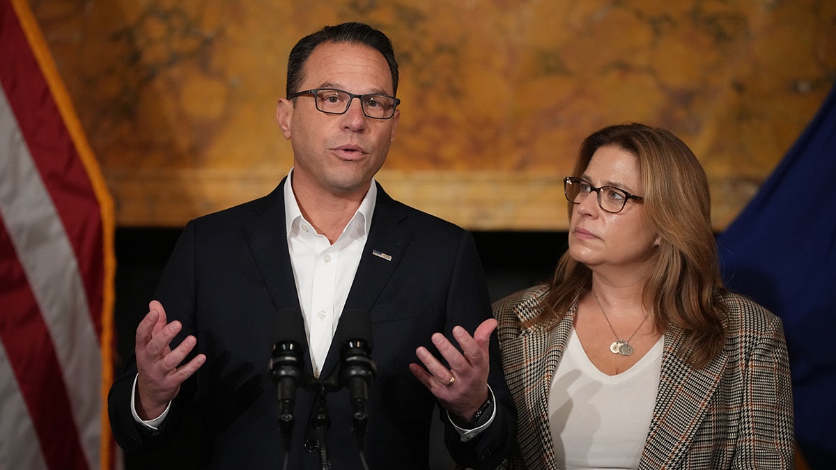 Pennsylvania Gov. Josh Shapiro gestures while speaking as his wife Lori Shapiro watches