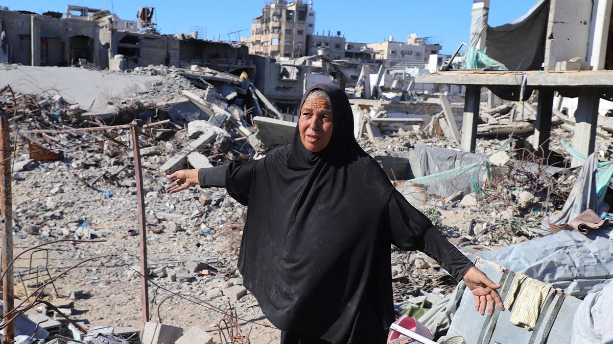 Woman in front of rubble in Gaza City