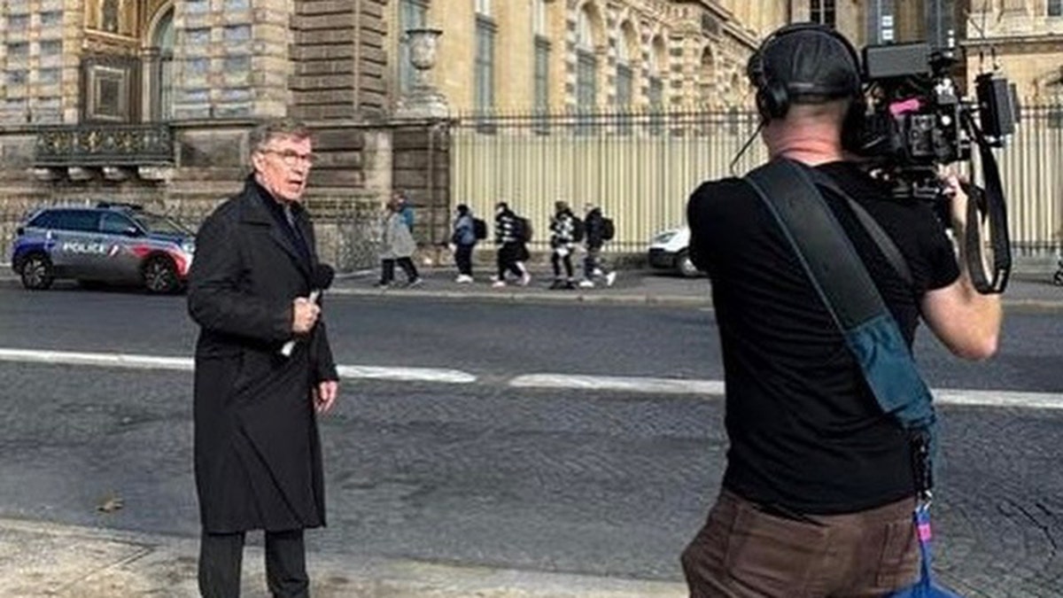 Greg Palkot standing outside the Louvre.